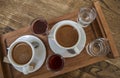 Cups of turkish coffee espresso, glasses of water and sweet cherry liqueur