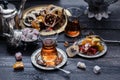 Cups of Turkish tea with oriental sweets on rustic wood Royalty Free Stock Photo