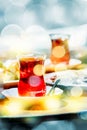 Cups of turkish tea and oriental sweets on the table in street cafe.