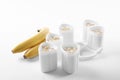 Cups of yogurt with bananas on white background Royalty Free Stock Photo