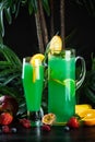 Curacao lemonade in a glass and jug decorated with an orange slice Royalty Free Stock Photo