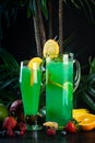 Curacao lemonade in a glass and jug decorated with an orange slice Royalty Free Stock Photo