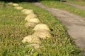 Curb stones concrete protection separation road way meadow landscape Royalty Free Stock Photo