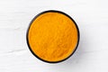 Curcuma turmeric powder on white wooden background Royalty Free Stock Photo