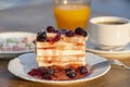 Curd cheese with red cherry jam, orange juice and cup coffee on table. Breakfast concept Royalty Free Stock Photo