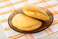 Curd envelopes in brown saucer on napkin on wooden table