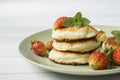 Curd pancakes with strawberries and mint on a plate Royalty Free Stock Photo