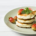 Curd pancakes with strawberries and mint on a plate Royalty Free Stock Photo
