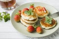 Curd pancakes with strawberries and mint on a plate Royalty Free Stock Photo