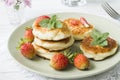 Curd pancakes with strawberries and mint on a plate Royalty Free Stock Photo