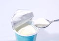 Curd with spoon on opened container