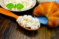 Curd on a wooden spoon on a board