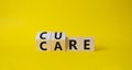 Cure and Care symbol. Turned wooden cubes with words Care and Cure. Beautiful yellow background. Business and cure and care Royalty Free Stock Photo