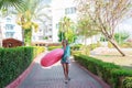 Cure girl is going to the beach with an inflatable circle and listening to music in headphones on her phone Royalty Free Stock Photo