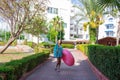 Cure girl is going to the beach with an inflatable circle and listening to music in headphones on her phone Royalty Free Stock Photo