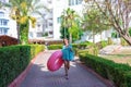 Cure girl is going to the beach with an inflatable circle and listening to music in headphones on her phone Royalty Free Stock Photo