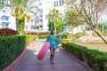 Cure girl is going to the beach with an inflatable circle and listening to music in headphones on her phone Royalty Free Stock Photo