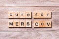 Cure for MERS CoV word written on wood block. stop cure for MERS CoV text on wooden table for your desing, coronavirus concept top