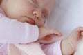 Cure Newborn baby girl sleeping in a pink crib