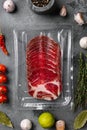 Cured meat coppa pack, on gray stone table background, top view flat lay Royalty Free Stock Photo