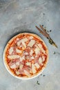 Cured parma ham on a Traditional Italian pizza with parmesan cheese and tomato on a thick pastry base. Italian Food. top view