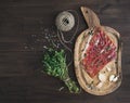 Cured pork meat or prosciutto on a rustic woodem board with garli Royalty Free Stock Photo