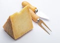 Cured sheep cheese Manchego type in wedge and cutlery. Isolate