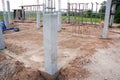 Concrete columns at the construction site are covered with plastic. Concrete curing method.