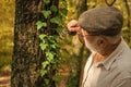 Curiosity to botany. Picky detective in forest. Explore nature. Pensioner with magnifier exploring forest autumn day