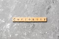 Curiosity word written on wood block. curiosity text on table, concept