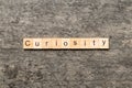 curiosity word written on wood block. curiosity text on table, concept