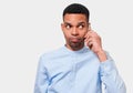 Curious African American young man talking on his smart phone. Afro male have a conversation with his girlfriend. People and Royalty Free Stock Photo