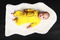 Curious baby boy lying on back on white fur Royalty Free Stock Photo