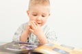 curious baby boy studying with the book Royalty Free Stock Photo