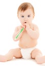 Curious baby brushing teeth