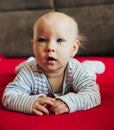 Curious baby girl lying on bed Royalty Free Stock Photo