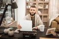 Curious bearded writer checking his writing progress