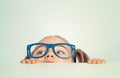 Curious beautiful cute little girl hiding under table and looking side Royalty Free Stock Photo