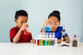 Curious black children experimenting in school chemistry laboratory