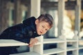 Curious boy in the city , stands leaning on the railing Royalty Free Stock Photo