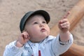 Curious boy, pointing with finger upwards