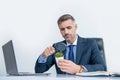 curious businessman look at plant through magnifying glass in business office Royalty Free Stock Photo