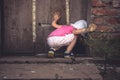 Curious child looking into dark hole in barn door in countryside shed concept curiosity