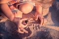 Curious child toddler playing on beach with hermit crab during summer vacation concept childhood curiosity lifestyle Royalty Free Stock Photo