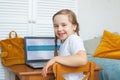 Curious child using laptop at home. Distance learning, hobby and leisure activity concept