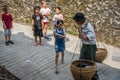 Curious children and man carrying heavy load