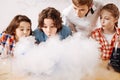 Curious clever children blowing on the chemical fume