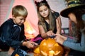 Cute friends playing with Halloween toys