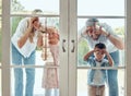 Curious couple with little kids standing and peering into their new home. Excited smiling caucasian family looking at Royalty Free Stock Photo