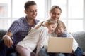 Curious cute children peeking on laptop using computer with pare Royalty Free Stock Photo